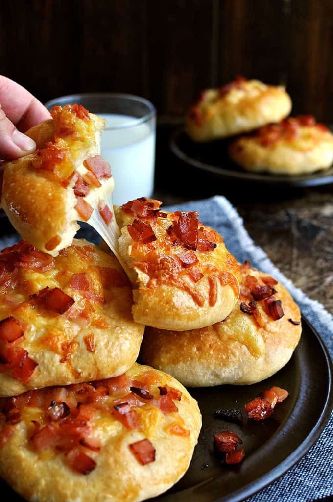 Pulling a chunk from a pile of Double Cheese and Bacon Rolls
