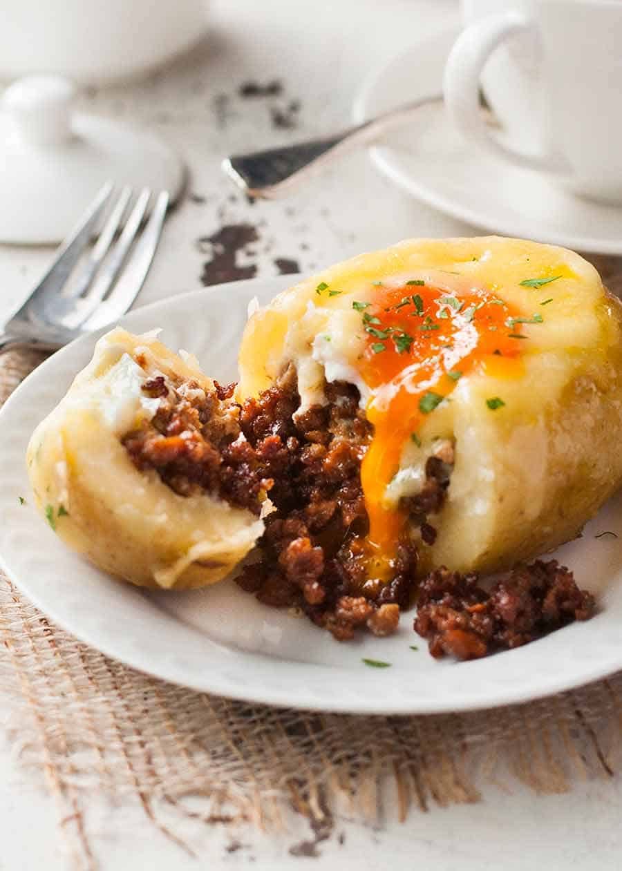 Close up of sausage spilling out of Sausage Egg Stuffed Potatoes