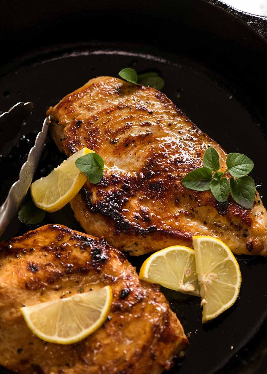 Cooked chicken breast (after marinated in Chicken Marinade) in black skillet , ready to be served