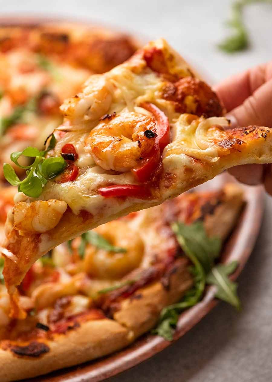 Showing structure of homemade pizza dough - slice of Prawn Pizza