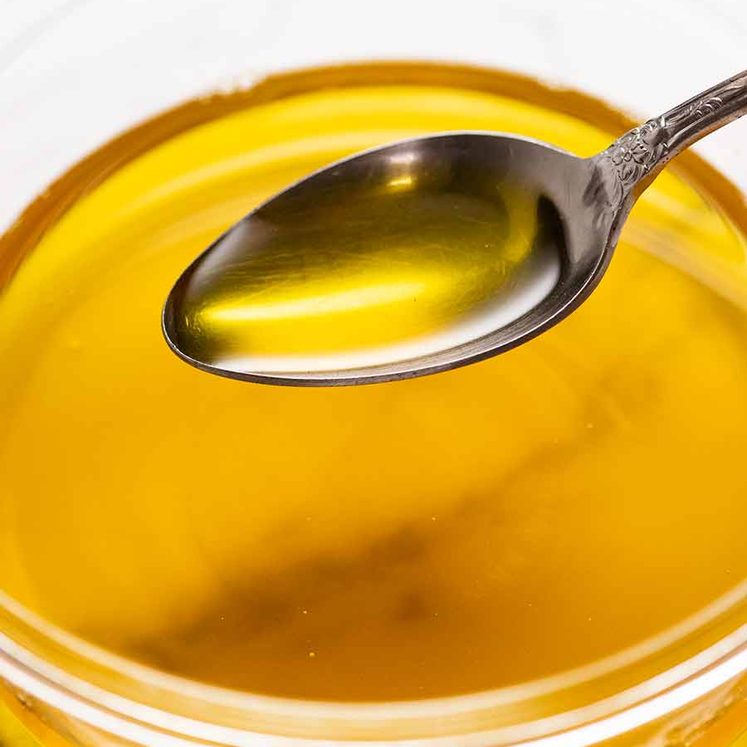 Spoon scooping up homemade ghee